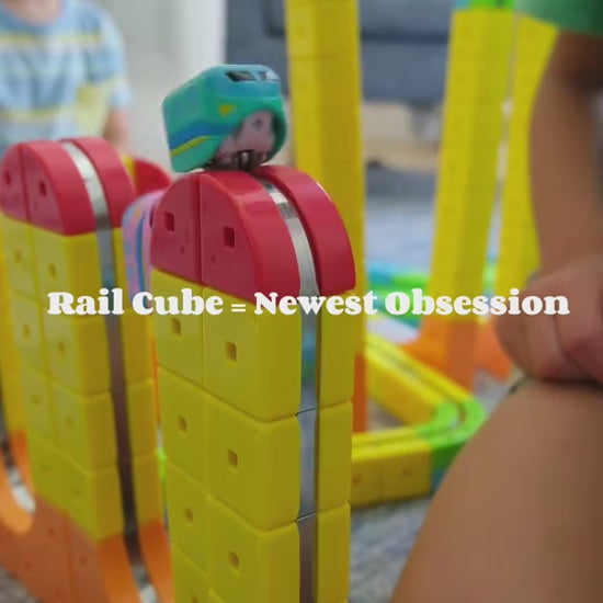Magnetic cube track toy set with car in use on a colorful modular track